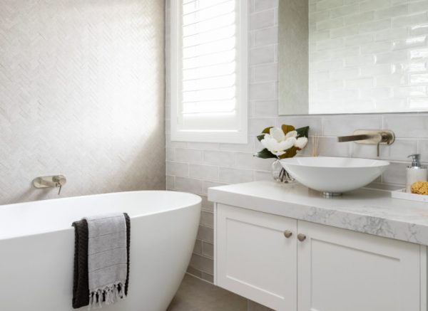 white bathroom interior with bathtub and wash basin