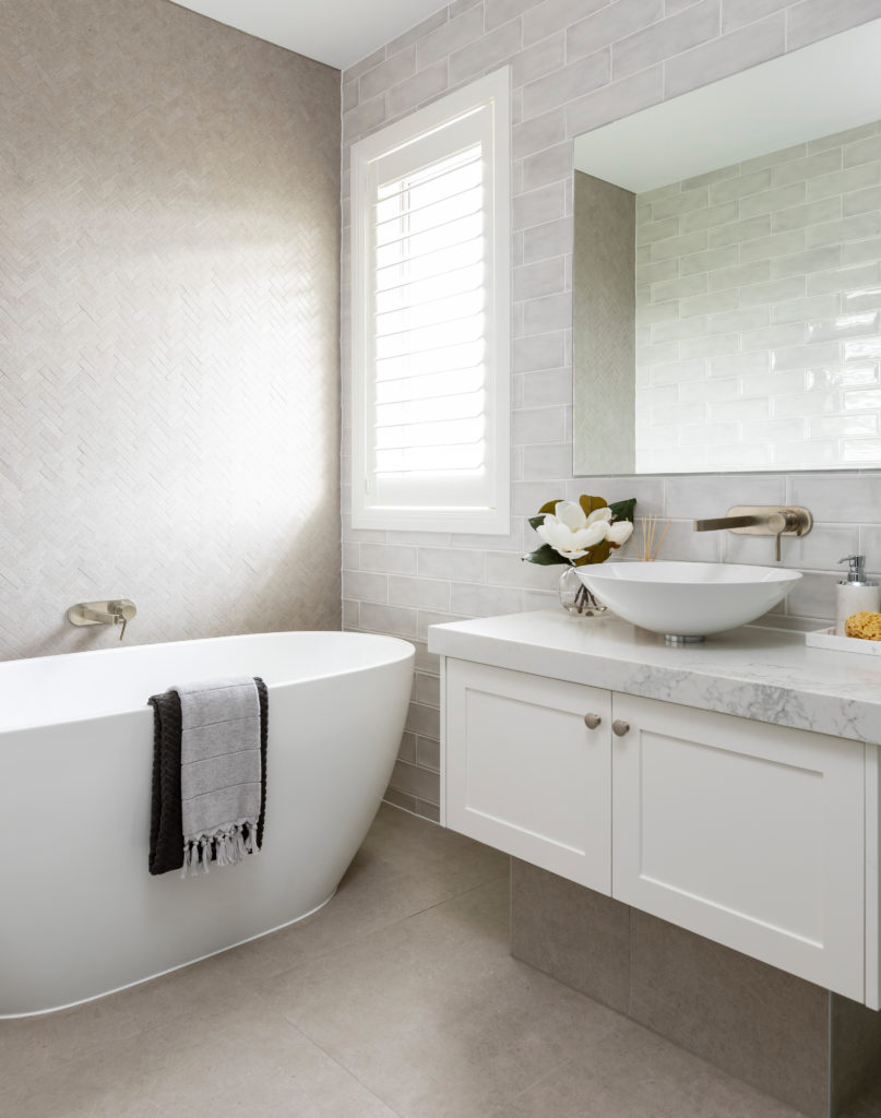 white bathroom interior with bathtub and wash basin